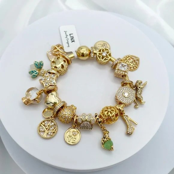 Linx Yellow Gold Bracelet with Gold and Green Themed Charms